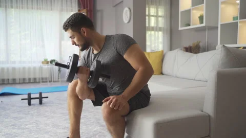Strong Athletic Man Exercising At Home, Training With Dumbbells. 스톡 동영상 219729380