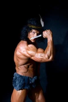 Strong athletic man with a knife Stock Photos