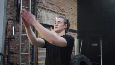 A strong athletic man is limbering up his hands Video stock 156301473