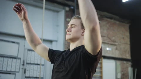 A strong athletic man is limbering up his hands Stock Footage 156301639