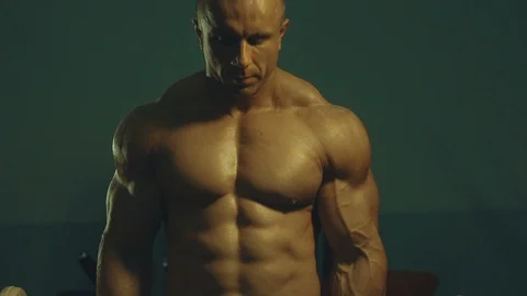 Strong athletic man pumping up biceps muscles workout fitness and bodybuilding Video stock 118774568