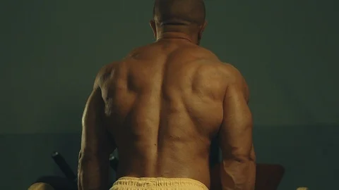 Strong athletic man pumping up biceps muscles workout fitness and bodybuilding Stock Footage 118775203