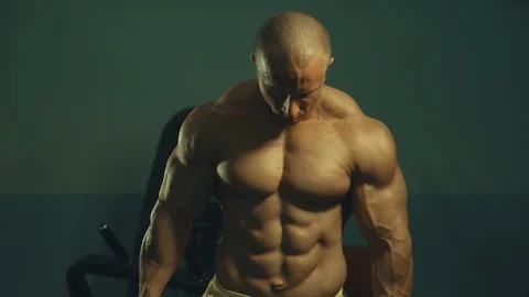 Strong athletic man pumping up biceps muscles workout fitness and bodybuilding Video stock 118776589