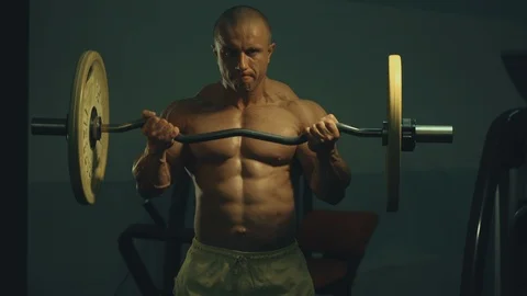 Strong athletic man pumping up biceps muscles workout fitness and bodybuilding Video stock 118776755