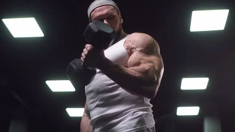 Strong athletic man pumping up muscles workout bodybuilding Stock-Footage 100036387