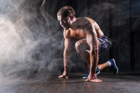 Strong athletic man sprinter ready to run. Professional athlete, runner train Stock Photos