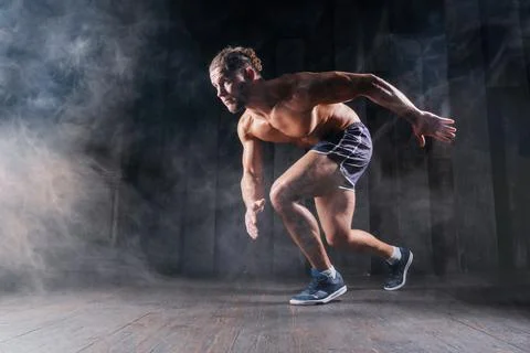 Strong athletic man sprinter ready to run. Professional athlete, runner train Stock Photos