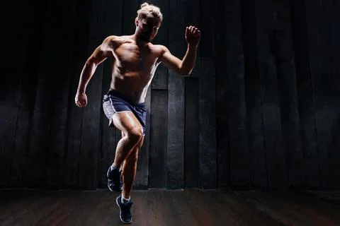 Strong athletic man sprinter ready to run. Professional athlete, runner train Stock Photos