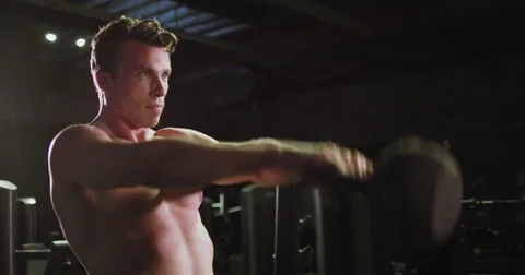 Strong athletic man working out with a kettleball weight Stock Footage 83183402