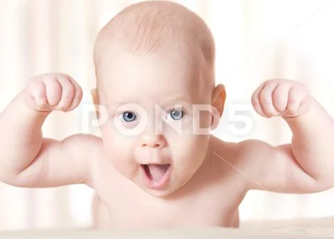 Strong baby arms raised up, smiling happy kid Stock Photos