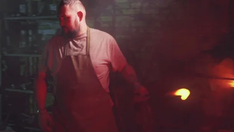 Strong bearded blacksmith is working in his forge Stock Footage 108032949