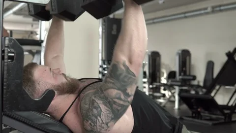 Strong bearded guy practicing with dumbbells close-up 4k. Stock Footage 85590449