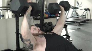 Strong bearded man training with dumbbells close-up 4k. Stock Footage 85590167
