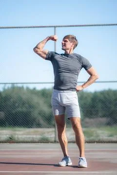 Strong biceps of man,, Athlete checking his muscles, doing sport exercises Stock Photos