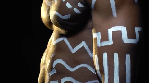 A strong black man with white patterns on his body and a necklace on his neck Stock Footage 82115448