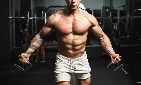 Strong bodybuilder doing exercise in the gym 스톡 사진