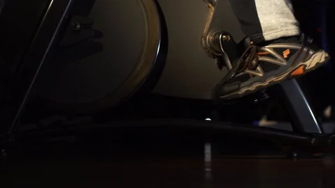 Strong bodybuilder doing exercises on an exercise bike against Stock Footage 87988476