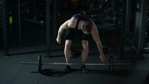 Strong bodybuilder easily raises up heavy barbell, training workout program Stock Footage 88578593