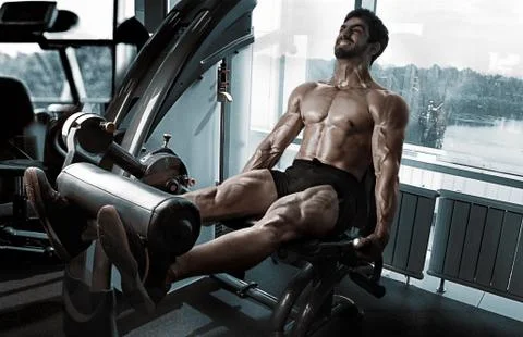 Strong bodybuilder training quads Stock Photos