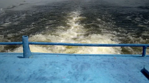 Strong boiling of water from the propellers of the ship. Crossing the river by Stock Footage 157071985
