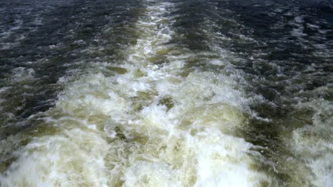 Strong boiling of water from the propellers of the ship. Crossing the river by Stock Footage 157072088