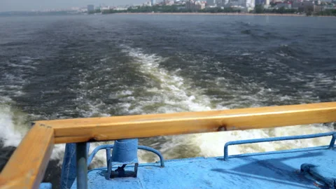Strong boiling of water from the propellers of the ship. Crossing the river by Stock Footage 157072269