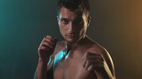 Strong Boxer In Dark Ring. Young Man Standing With Naked Torso. Piercing Gaze. Stock Footage 160769313