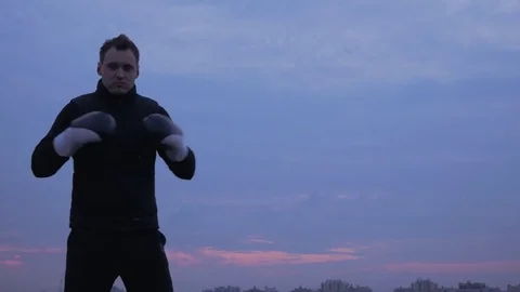 Strong boxer on the sky background invites to the ring fight Stock Footage 83366659