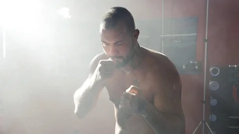 Strong boxer training and moving punching thinking about match in gym slow mo Stock Footage 80965280
