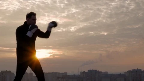 Strong boxer training at sunset Stock Footage 83325646