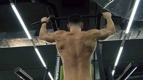 Strong boy doing pull-ups in the gym. Stock Footage 99095732