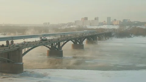 Strong bridge stands in middle of river, hidden by a smokescreen. Drone shooting Stock Footage 113749215