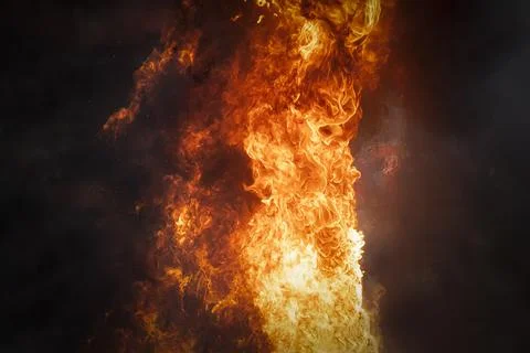 Strong bright flame of fire on a dark background. Foto stock