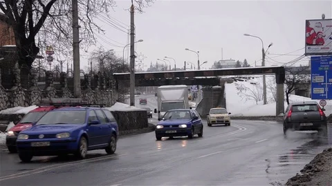 Strong car traffic on a crowded road over which a train passes on a concrete Stock Footage 80267904