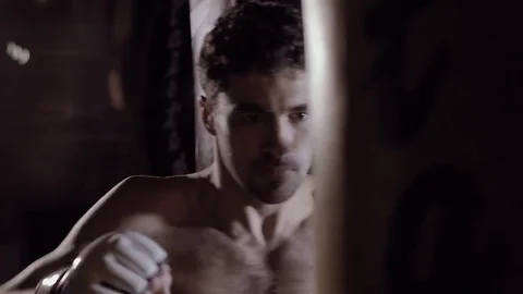 Strong caucasian man boxing using punch sake in studio with artificial light. Stock-Footage 76917667