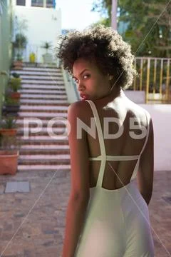 Strong, chic young woman turning to camera, waist up Stock Photos