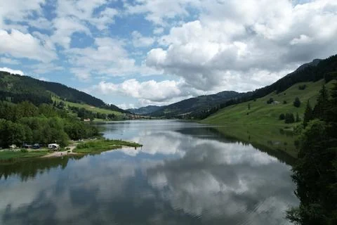 Strong Cloud Reflections on Schwarzsee Alpine Lake, Switzerland Foto stock