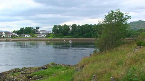 Strong current during falling tide at mouth of loch Stock Footage 39654400