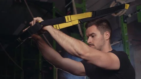 Strong dark haired male doing  TRX triceps press exercise Stock Footage 131232724