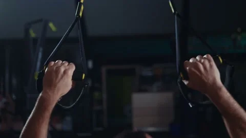 Strong dark haired male doing  TRX inverted row exercise Video stock 131232868