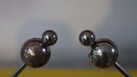 Strong electric spark between two iron balls on gray background Stock Footage 223286418