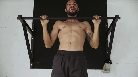 Strong fit man does pullups in gym Stock Footage 77416459