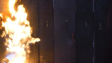 A strong flame from a gas torch directed on the wooden planks. Stock Footage 118854586