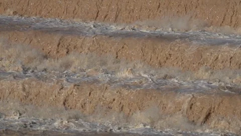 Strong flow of water and mud on a riverbed, in slow motionACQUA7SLOW Stock Footage 294919332
