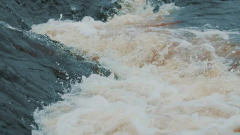 Strong flow water with splashes and foam in slow motion. Powerful raging river Stock Footage 157371026