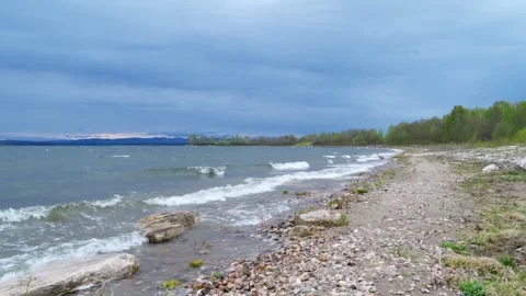 Strong gusts of wind and big waves on the shore of the lake. Natural landscape. Stock Footage 275081451