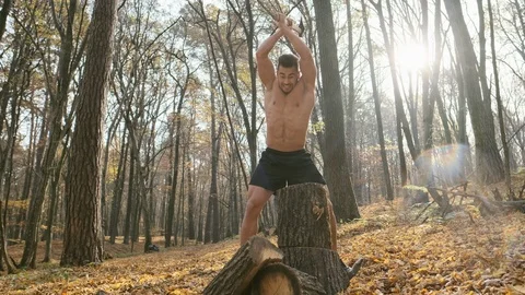 Strong Guy With Naked Torso Cuts Firewood With An Ax In The Forest. Stock Footage 120652247