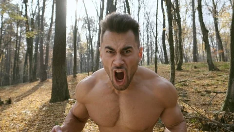 Strong Guy With Naked Torso. Guy In The Woods. He Yells Loudly. Shows Its Power. Stock-Footage 120747981