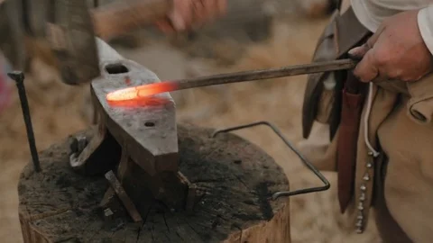 Strong hammer blows on the anvil and iron rod Stock Footage 79998460