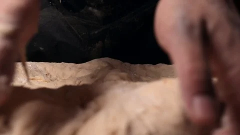 Strong hands knead the dough on the table Stock Footage 124960231